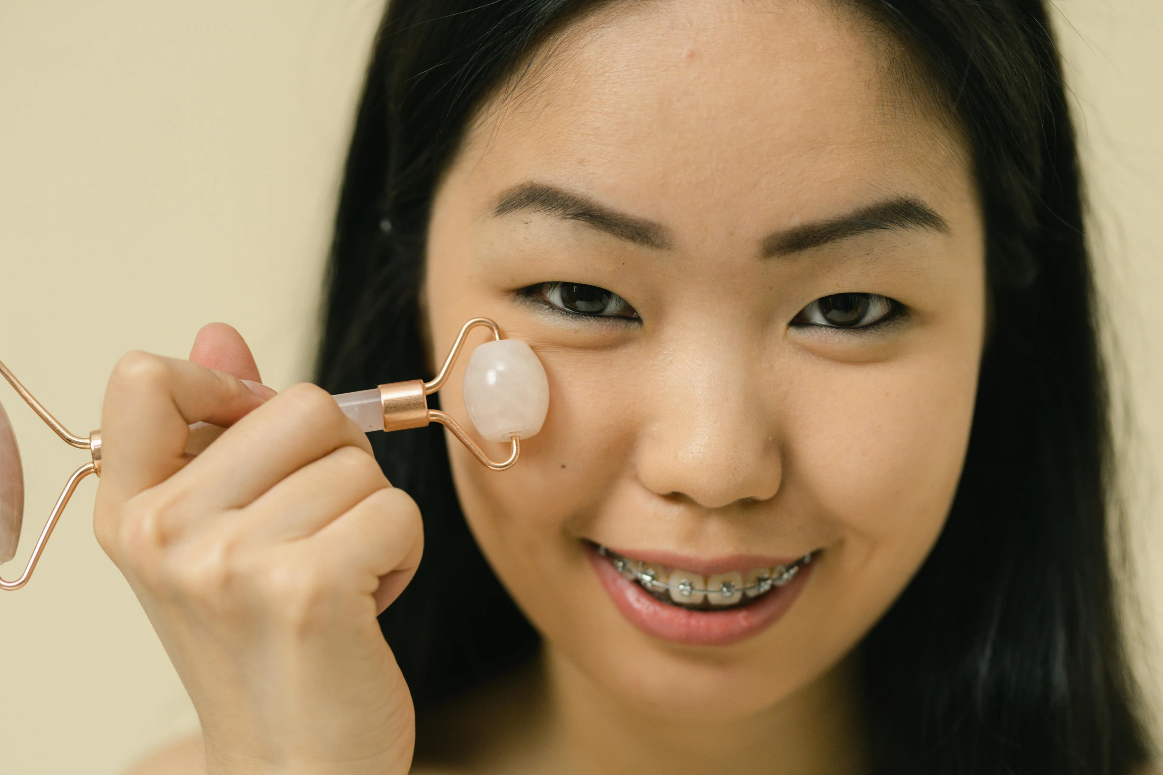 a close up of a person holding a pair of scissors, asian face, soft oval face, bells, silicone skin