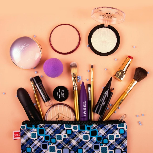 a purse filled with makeup and brushes on top of a pink background, by Gina Pellón, pexels contest winner, black and blue and purple scheme, miscellaneous objects, game ready, complimentary eyeliner