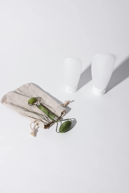 a couple of cups sitting on top of a white table, small vials and pouches on belt, product view, green pupills, detailed product image