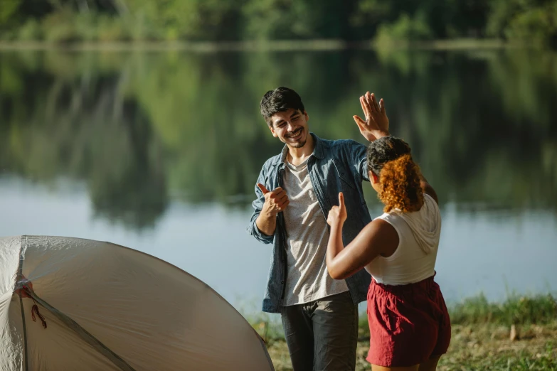 a man and a woman standing next to a tent, pexels contest winner, waving arms, lake setting, flirting, avatar image