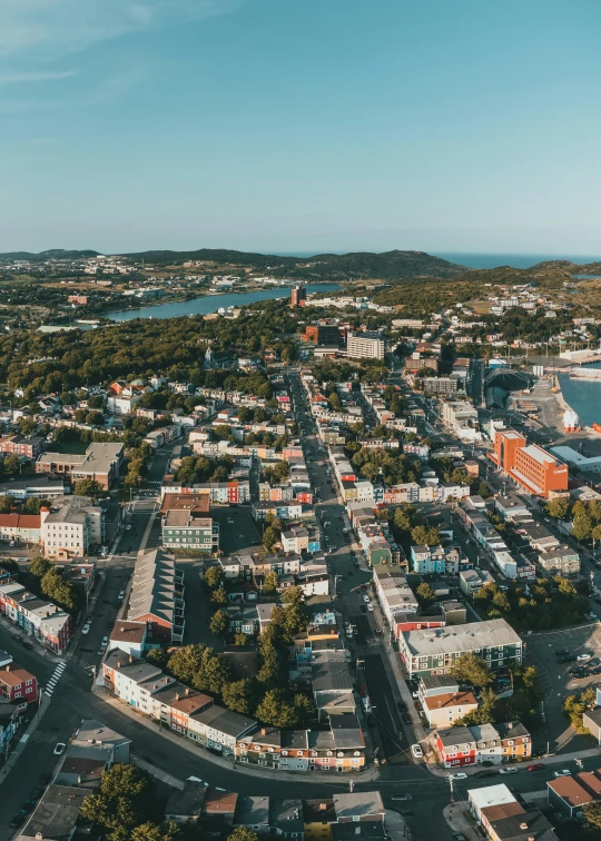 an aerial view of a city with lots of buildings, by Greg Rutkowski, pexels contest winner, happening, island, 4 k cinematic panoramic view, looking over west virginia, slide show