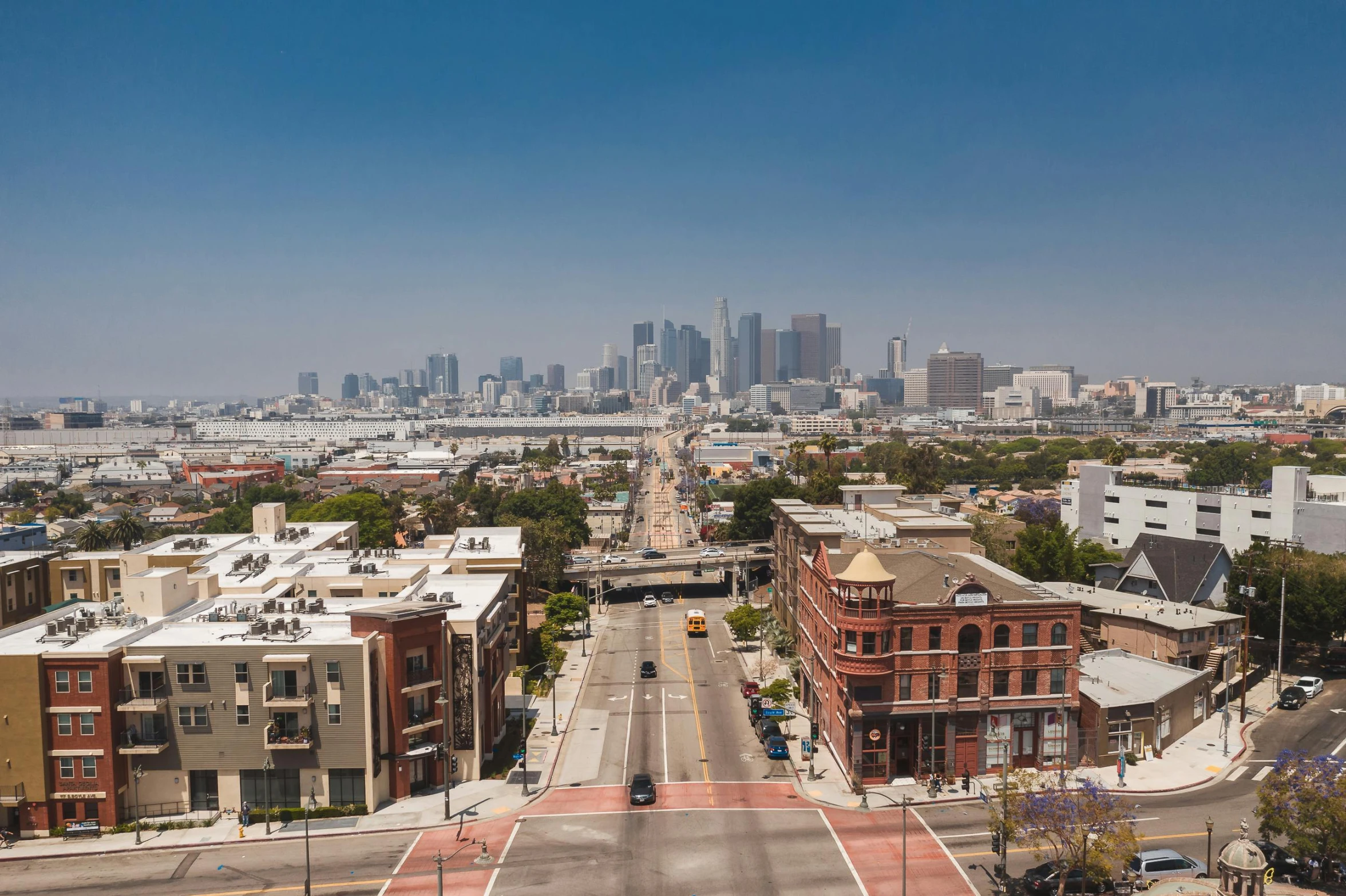 a view of a city from the top of a building, by Ryan Pancoast, unsplash, photorealism, 1600 south azusa avenue, bright sunny day, taken in the early 2020s, 2000s photo