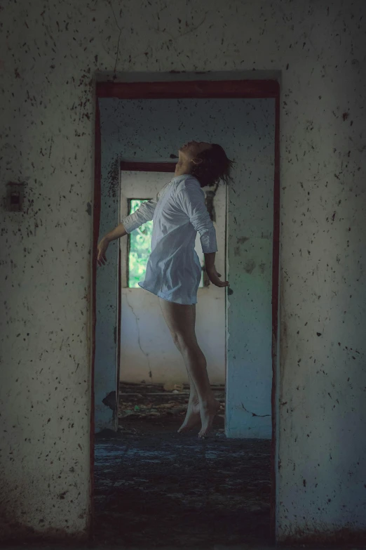 a woman in a white dress standing in a doorway, an album cover, inspired by Elsa Bleda, magical realism, in a decayed hospital room, falling from sky, pose model, falling