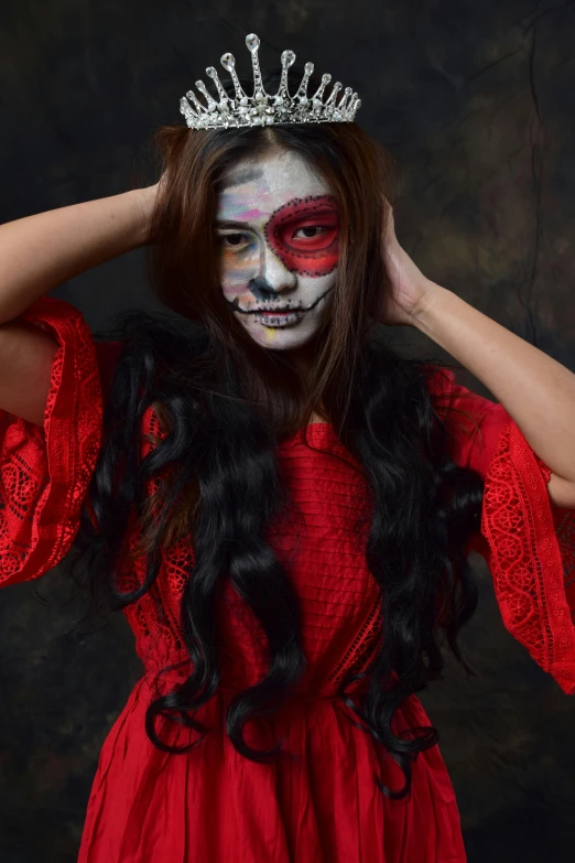 a woman in a red dress with a crown on her head, by reyna rochin, pexels contest winner, gothic art, skull face paint, she is mexican, red facial stripe, wearing a skeleton armor