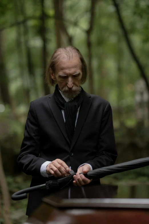 a man in a suit holding a baseball bat, by Winona Nelson, hold sword in the forest, colin hay, an oldman, ignant