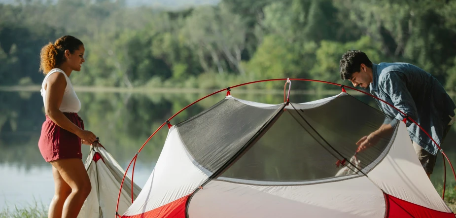 a man and woman setting up a tent next to a lake, silver white red details, nonagon infinity, detail shot, high elevation