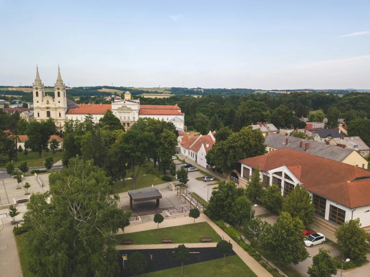 a view of a town from a bird's eye view, by Emma Andijewska, old abbey in the background, parks and monuments, white, square