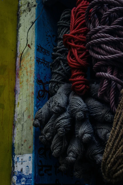 a pile of yarn sitting on top of a table, a picture, inspired by Steve McCurry, unsplash contest winner, ropes and chains, nepal, industrial colours, contrast colors