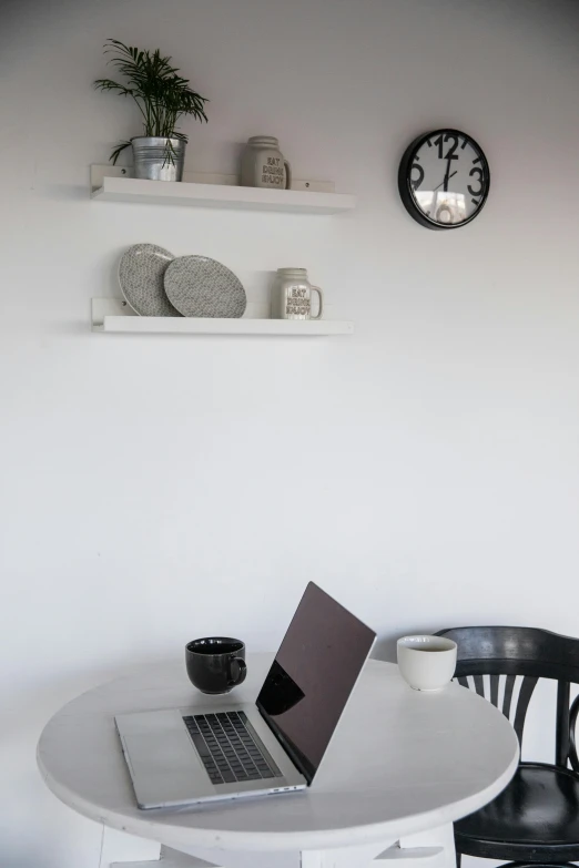 a laptop computer sitting on top of a white table, a still life, unsplash, minimalism, shelves, low quality photo, breakfast, dwell