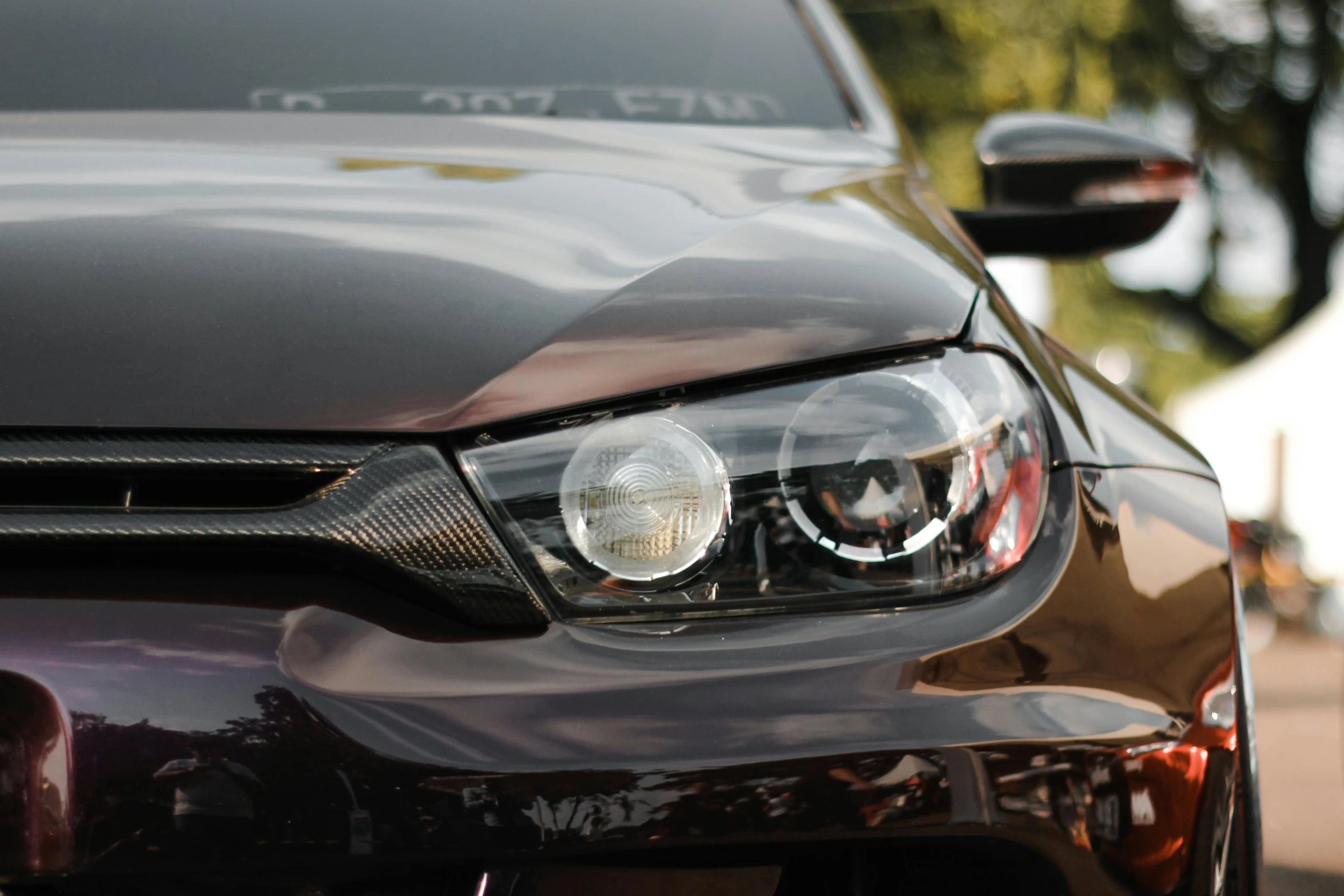 a close up of the headlights of a car, inspired by An Gyeon, pexels contest winner, brown, high body detail, profile picture, black car