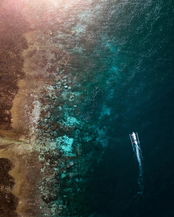 a couple of boats floating on top of a body of water, a screenshot, pexels contest winner, coral sea bottom, bird\'s eye view, quixel megascans, bali