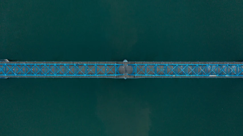 an aerial view of a bridge over a body of water, by Jacob Toorenvliet, pexels contest winner, hurufiyya, industrial colours, blue: 0.5, composite, near a jetty