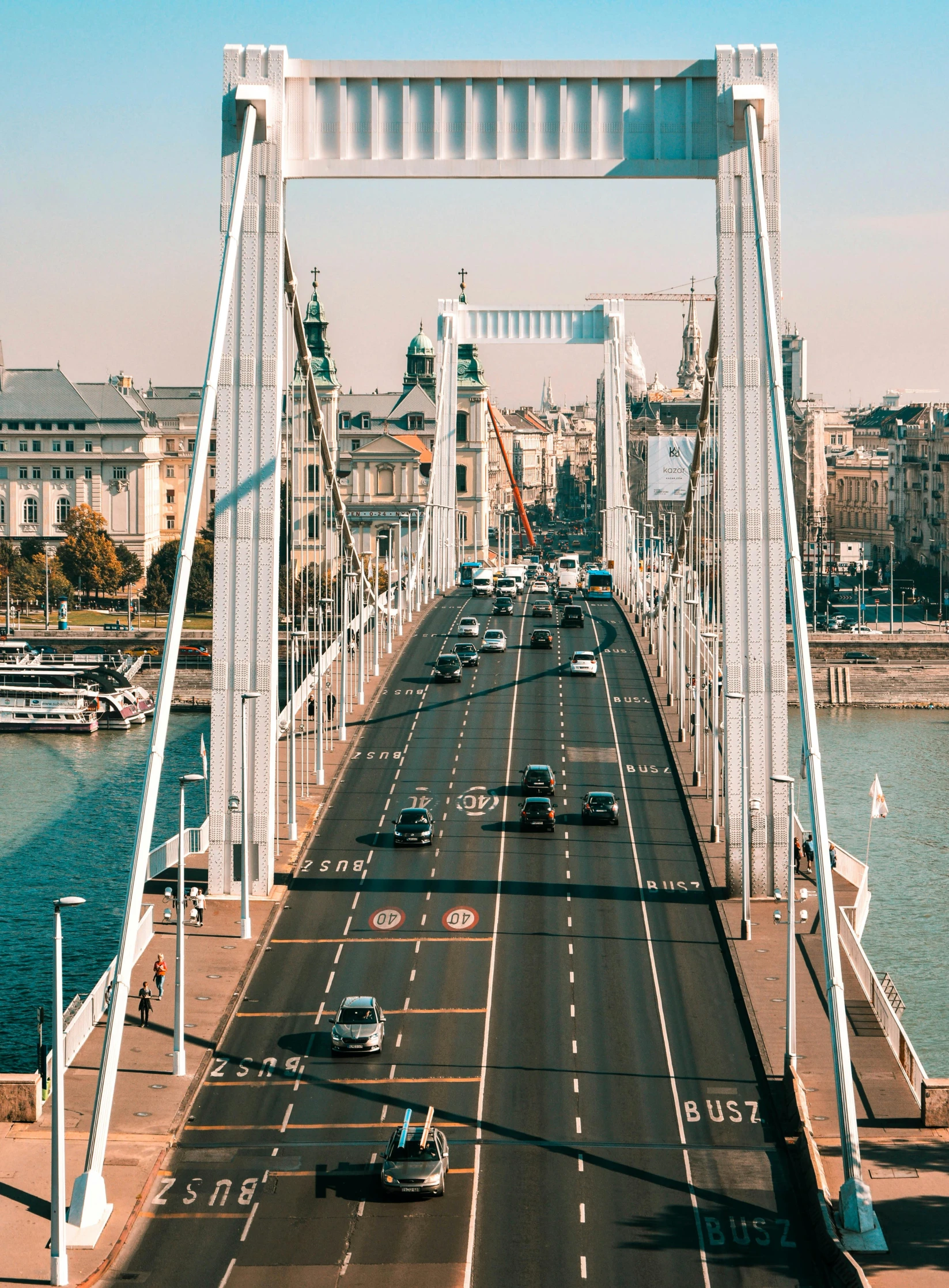 a bridge over a body of water with cars driving on it, a photo, by Matija Jama, pexels contest winner, budapest street background, high quality product image”, long view, brochure