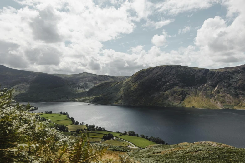 a large body of water sitting on top of a lush green hillside, by John Atherton, pexels contest winner, hurufiyya, lakes, slate, jane austen, high quality product image”