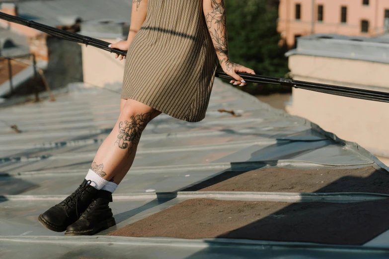 a woman walking up a flight of stairs, a tattoo, inspired by Elsa Bleda, trending on pexels, wearing skirt and high socks, rooftop, tatoos, androgynous person