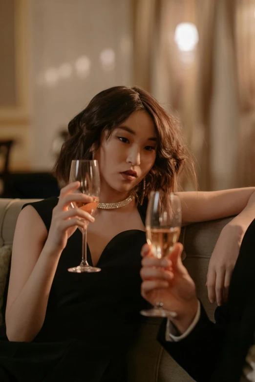 a man and a woman sitting on a couch holding wine glasses, by Niko Henrichon, trending on pexels, renaissance, female actress from korea, pouting, champagne, single figure