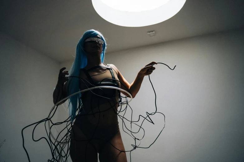 a woman with blue hair standing in a room, unsplash, interactive art, black wired cables, pvc poseable, adult swim style, instagram photo