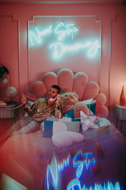 a woman sitting on a bed in front of a neon sign, an album cover, inspired by Elsa Bleda, trending on pexels, brightly lit pink room, bad bunny, manic pixie dream girl, 3d feeling