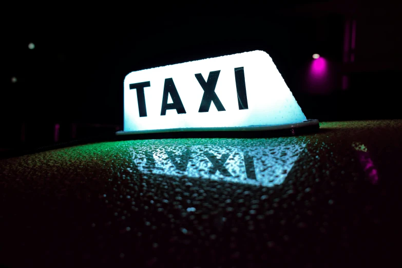 a taxi sign sitting on top of a car, by Joe Bowler, unsplash, reflecting light in a nightclub, avatar image