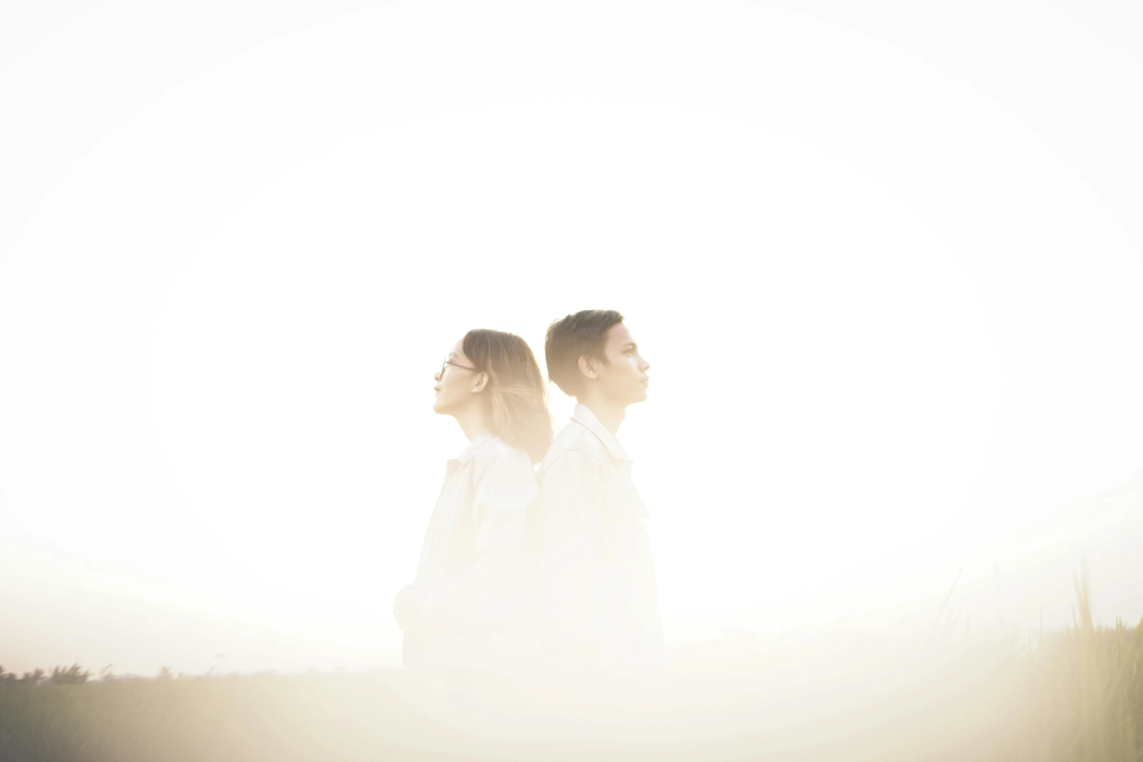 a man and a woman standing next to each other, a picture, by Adam Marczyński, unsplash, romanticism, white fog, translucent, boy and girl, backlight photo sample