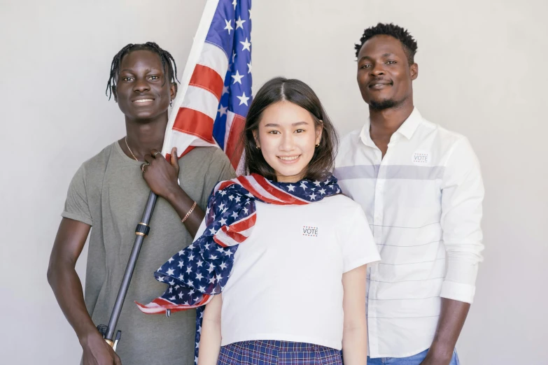 three people standing next to each other holding an american flag, pexels contest winner, renaissance, adut akech, pokimane, outlive streetwear collection, college students