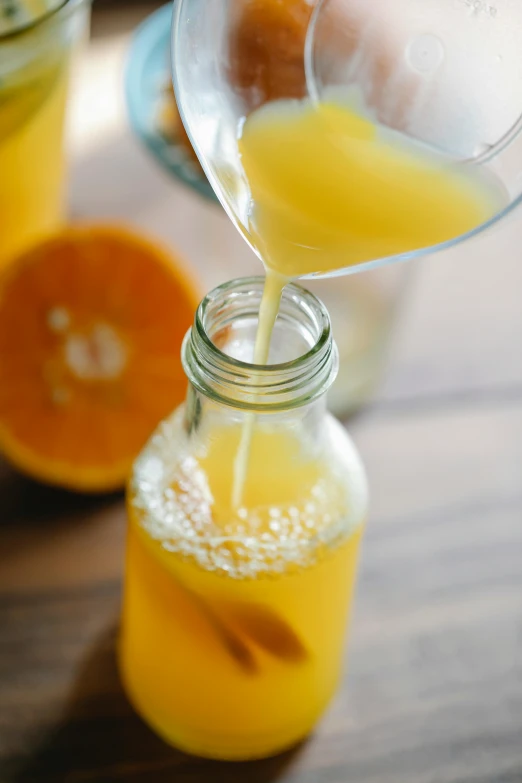 a person pouring orange juice into a glass, thumbnail, petite, 1x, deep image