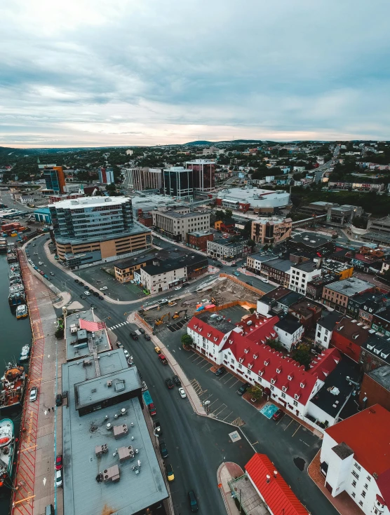 an aerial view of a city with lots of buildings, by Brian Snøddy, pexels contest winner, happening, shipyard, town square, thumbnail, slide show