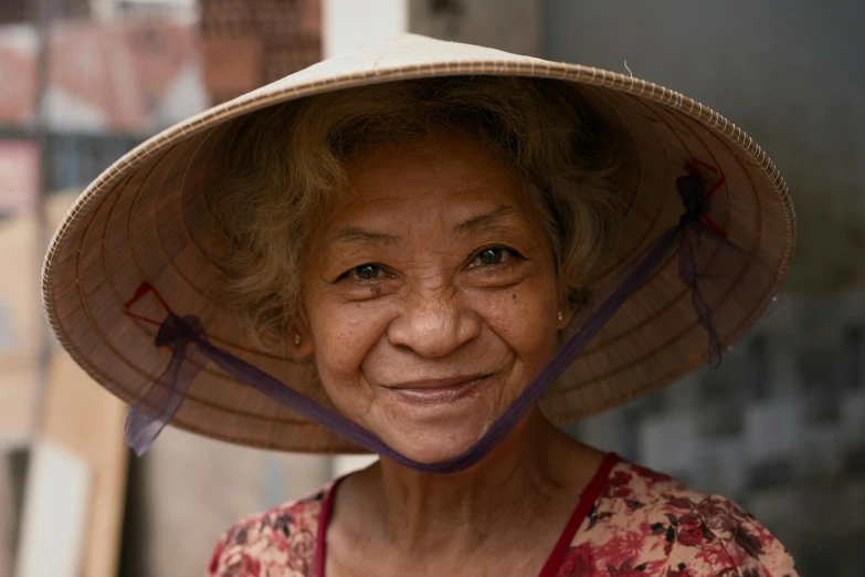 a close up of a person wearing a hat, inspired by Ruth Jên, pexels contest winner, cloisonnism, smiling for the camera, vietnam, avatar image, grandma
