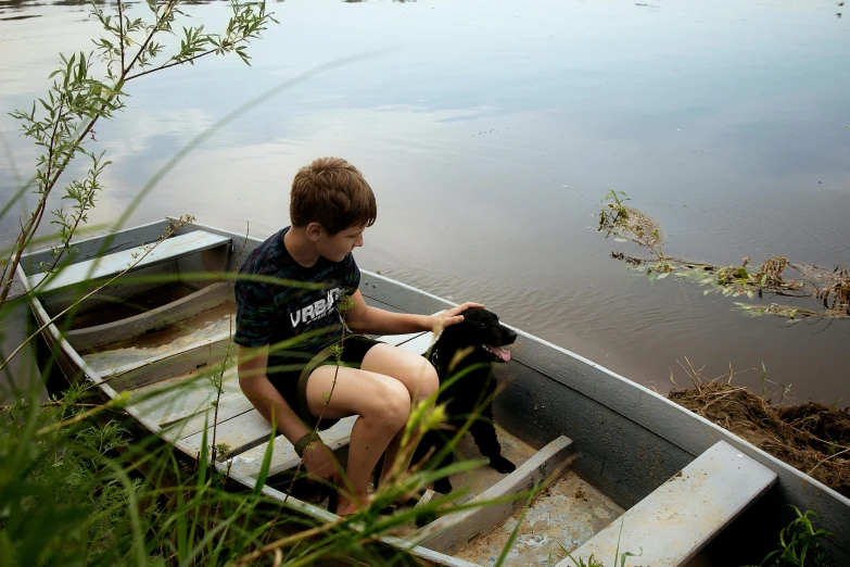 a boy and his dog are sitting in a small boat, by Jessie Algie, pexels contest winner, tar pit, thumbnail, lachlan bailey, skiff