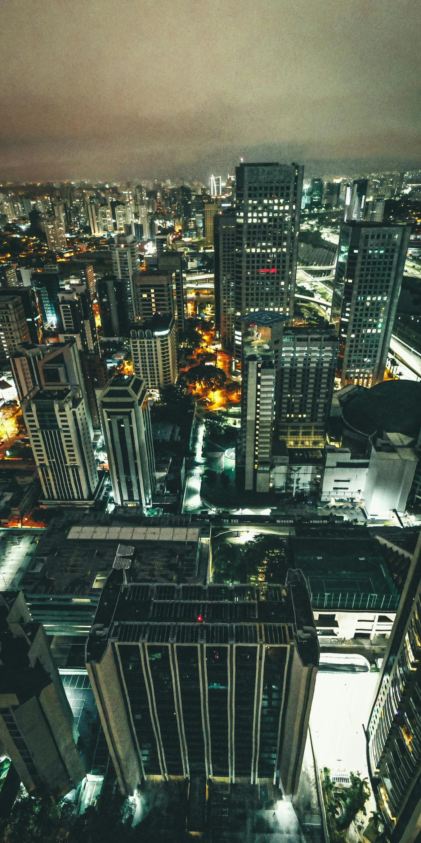 an aerial view of a city at night, an album cover, pexels contest winner, philippines, highrise business district, low quality photo