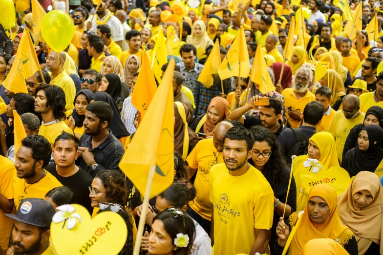 a large group of people holding yellow flags, pexels, hurufiyya, sri lanka, profile image, ghailan!