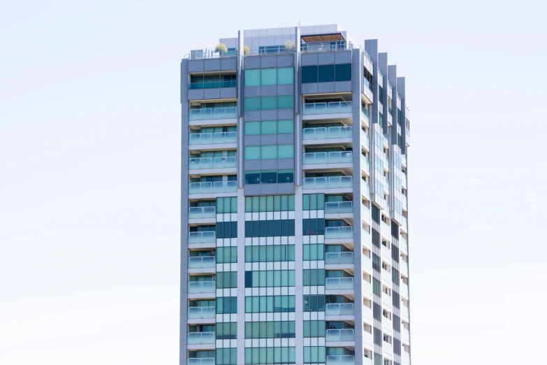 a very tall building with a lot of windows, unsplash, hurufiyya, aquamarine windows, taken in the 2000s, ten flats, te pae
