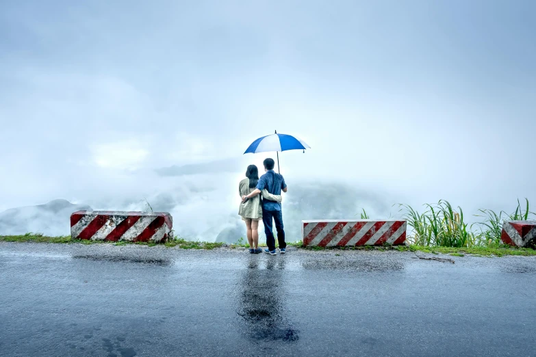 two people standing in the rain with an umbrella, pexels contest winner, on the top of a hill, avatar image, roadside, maintenance photo