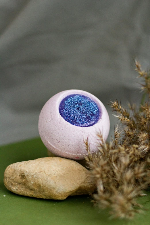 a bath ball sitting on top of a green plate, lavender blush, lapis lazuli, bio-inspired, stone ocean