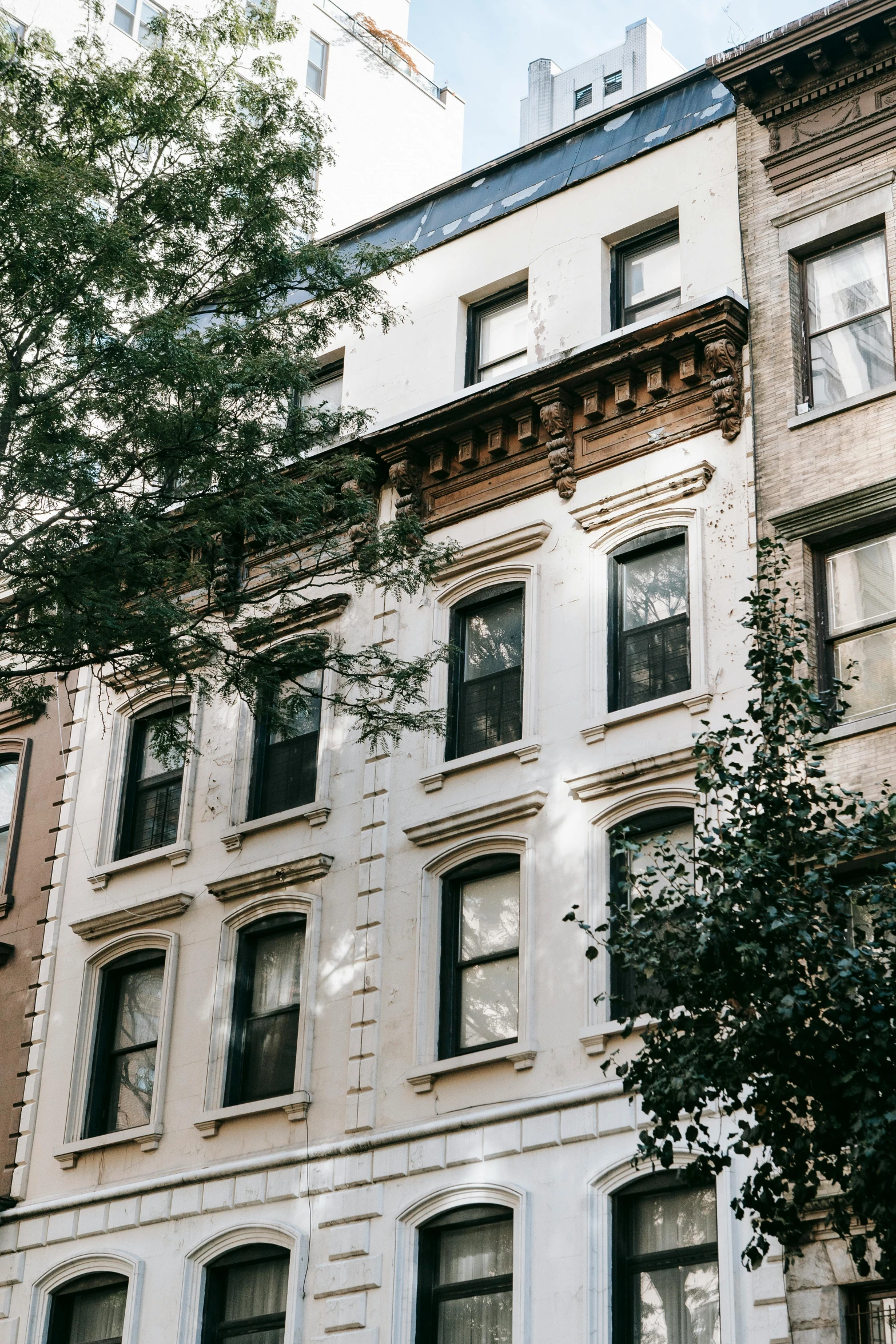 a couple of buildings that are next to each other, by Nina Hamnett, trending on unsplash, art nouveau, cramped new york apartment, white houses, ignant, lush surroundings