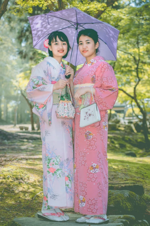 a couple of women standing next to each other holding umbrellas, a picture, inspired by Uemura Shōen, unsplash, fujicolor photo, 🚿🗝📝, in robes, square