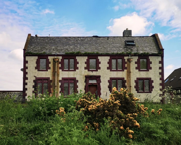 a house sitting on top of a lush green hillside, an album cover, by Jessie Algie, unsplash, renaissance, derelict house, maryport, front facing, in the style wes anderson