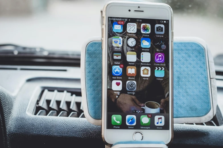 a cell phone sitting on top of a car dashboard, by Carey Morris, pexels, square, apple, tall, diy