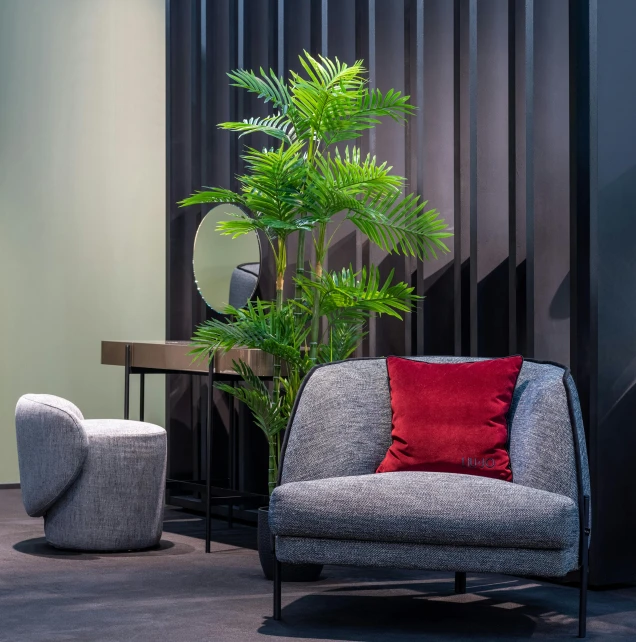 a living room filled with furniture and a potted plant, inspired by Emilio Grau Sala, dezeen showroom, lush foliage cyberpunk, armchair, payne's grey and venetian red