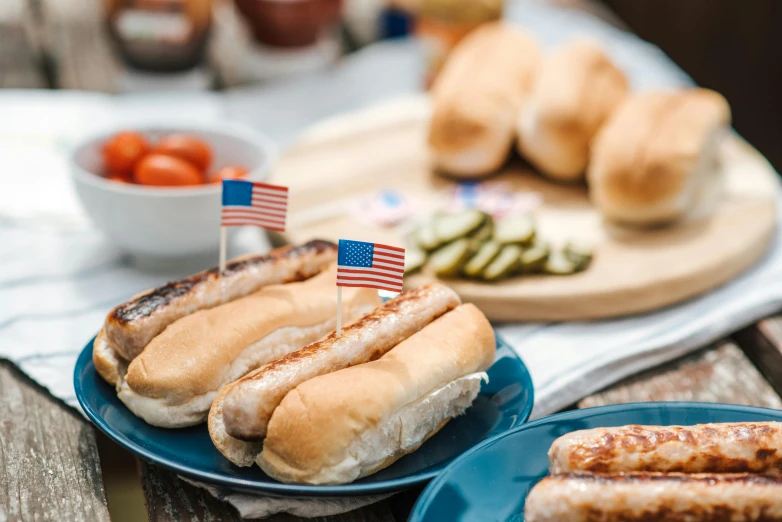 a table topped with plates of hot dogs and buns, by Julia Pishtar, fourth of july, profile image, thumbnail, up close