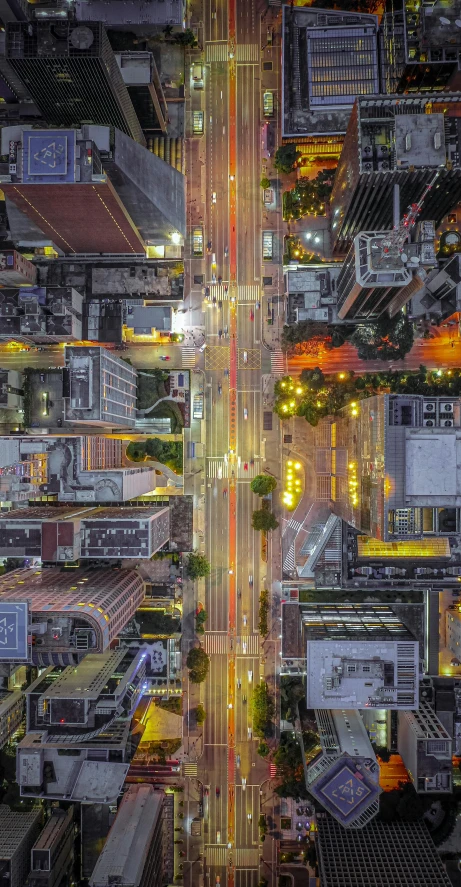 an aerial view of a city at night, by Dan Christensen, pexels contest winner, photorealism, detailed street, drone photograpghy, a colorful, low angle shot