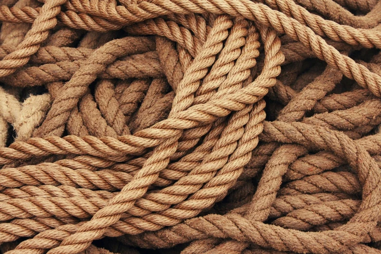 a pile of rope sitting on top of a table, brown colours, tans, mid-twenties, intricate