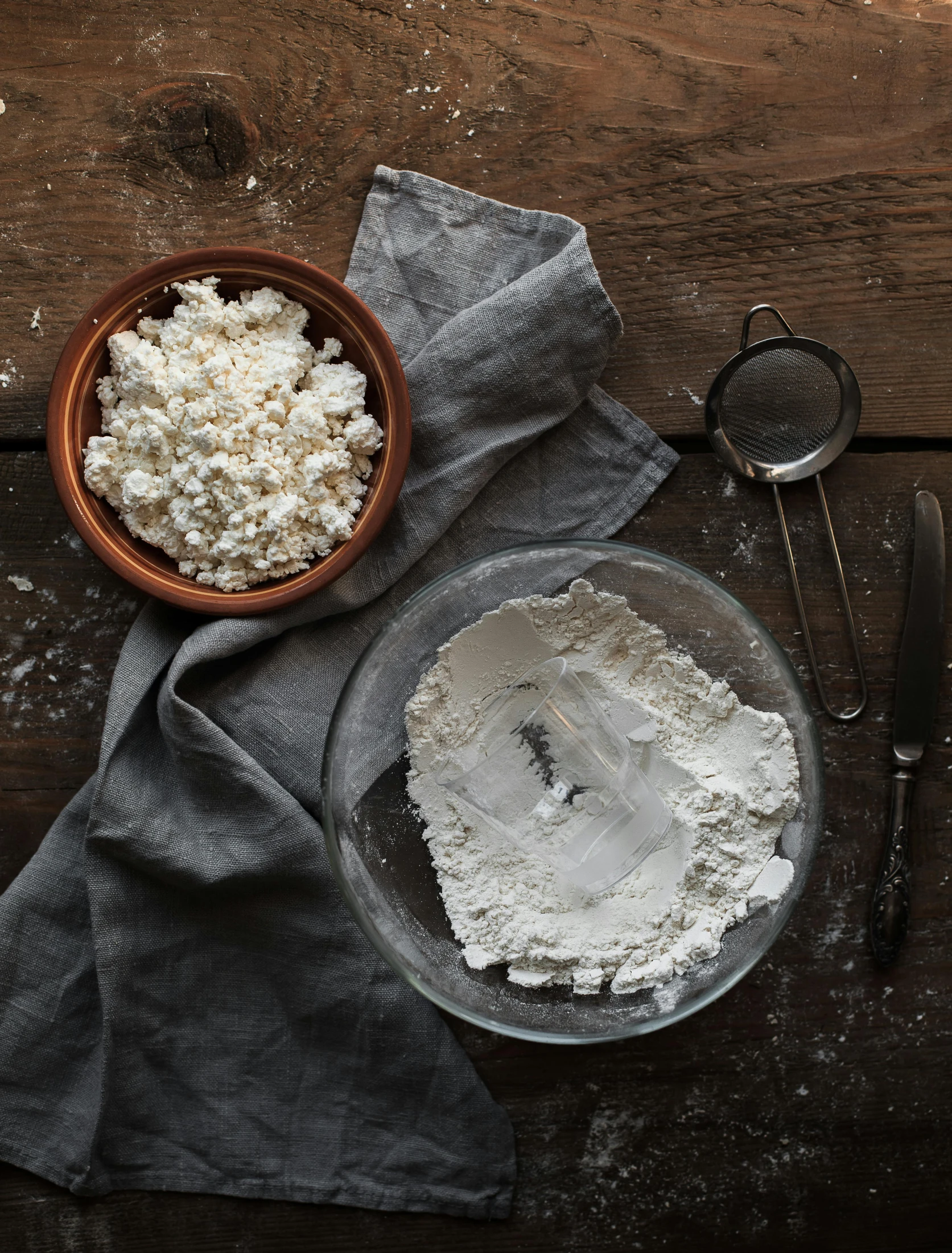 a bowl of flour sitting on top of a wooden table, a portrait, unsplash, process art, background image, deconstructed waffle, plenty mozzarella, laura watson