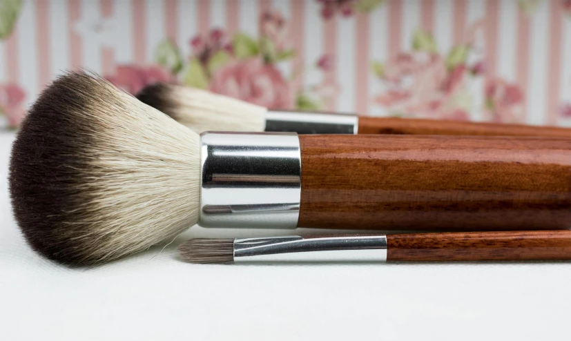 a couple of brushes sitting on top of a table, pixabay, photorealism, vintage makeup, botanicals, highly polished, blushing