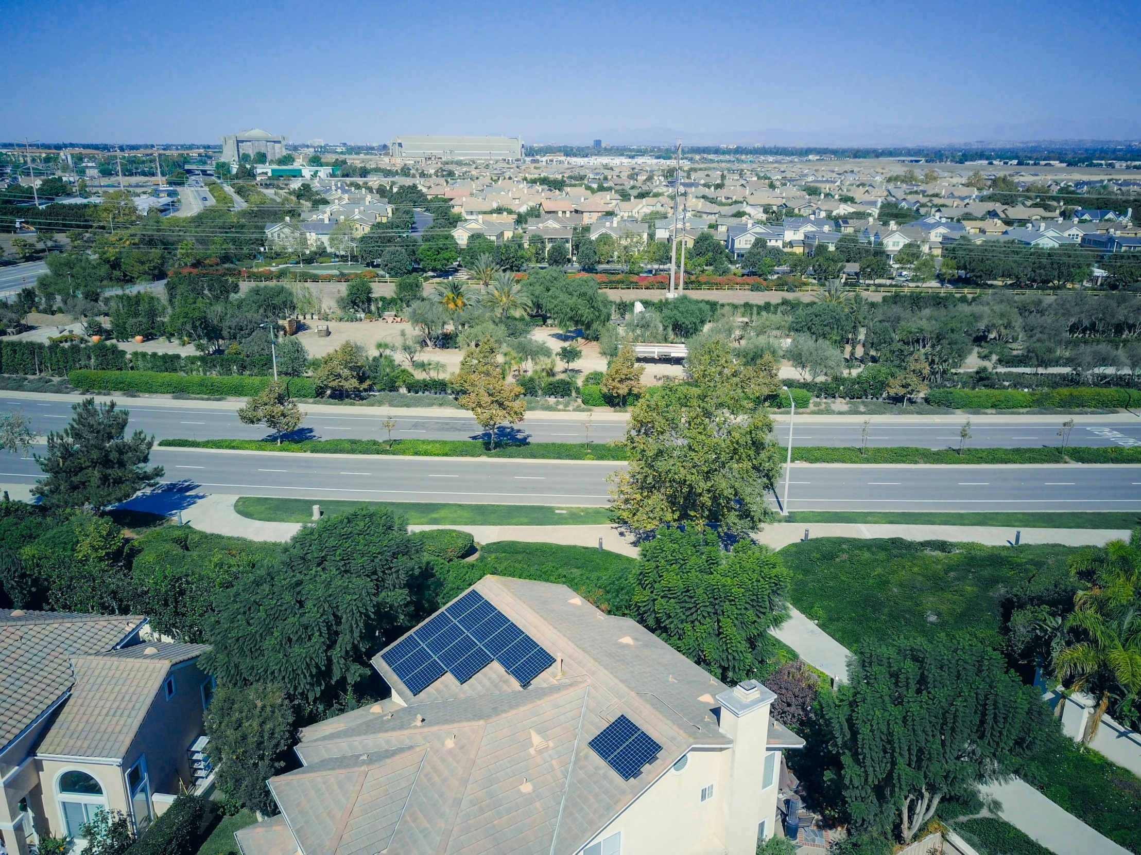 a house with solar panels on the roof, by Ryan Pancoast, 4k drone photography, city view, carson ellis, eyelevel!!! view!!! photography