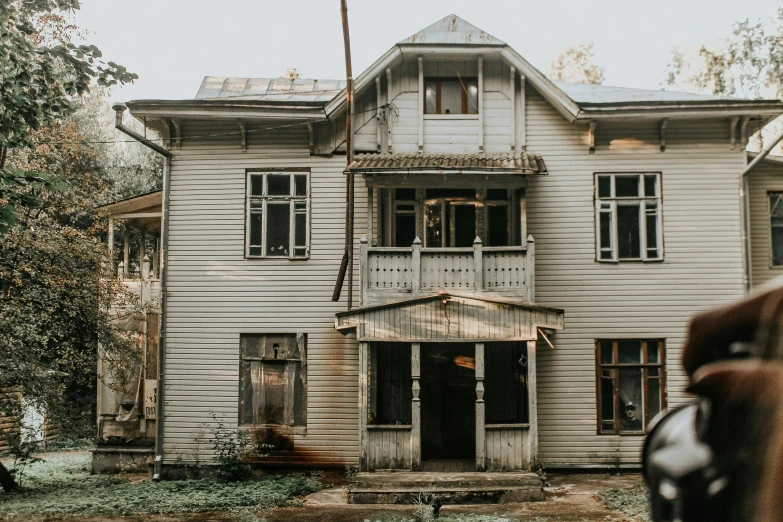 a horse that is standing in front of a house, by Emma Andijewska, pexels contest winner, art nouveau, dystopian 1920s soviet mood, peaceful wooden mansion, background image, burned