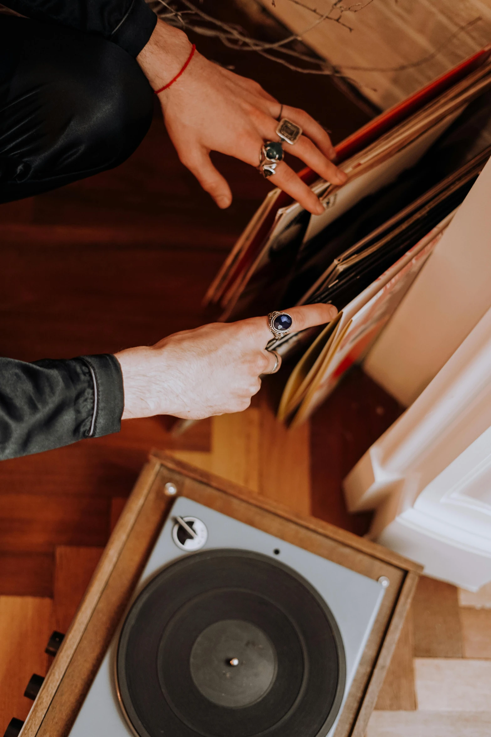 a person holding a record in front of a record player, an album cover, curated collections, brown, birdseye view, instagram story