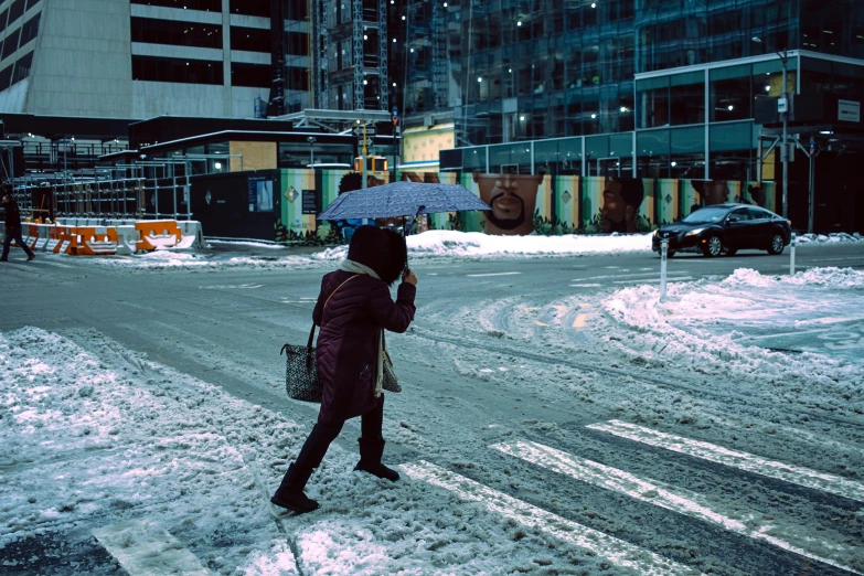 a woman walking across a snow covered street holding an umbrella, a photo, inspired by Elsa Bleda, unsplash contest winner, hyperrealism, toronto city, snapchat photo, in cyberpunk city, intersection