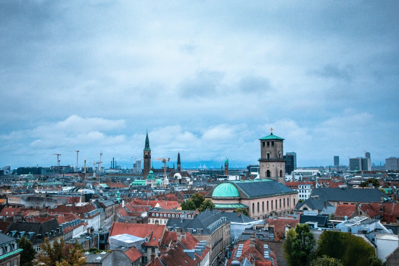 a view of a city from the top of a hill, a colorized photo, by Jakob Gauermann, pexels contest winner, nuremberg, brown and cyan blue color scheme, denmark, grey
