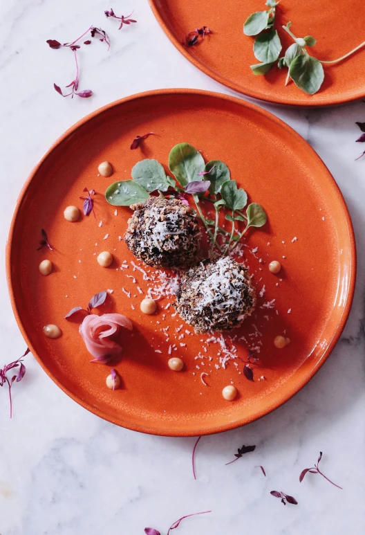 a close up of two plates of food on a table, inspired by Serafino De Tivoli, unsplash, vanitas, luscious patty with sesame seeds, energy spheres, in front of an orange background, instagram picture